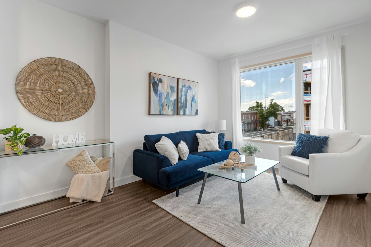 Modern living room with a blue velvet sofa and armchair.